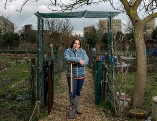  Une salariée de Plaine Commune pose dans la parcelle qu'elle loue avec sa famille dans les jardins ouvriers de Stains. Mars 2018.